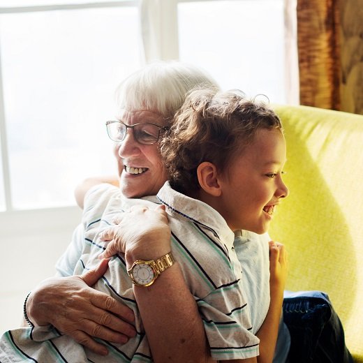 Grandma and grandson hugging after social distancing